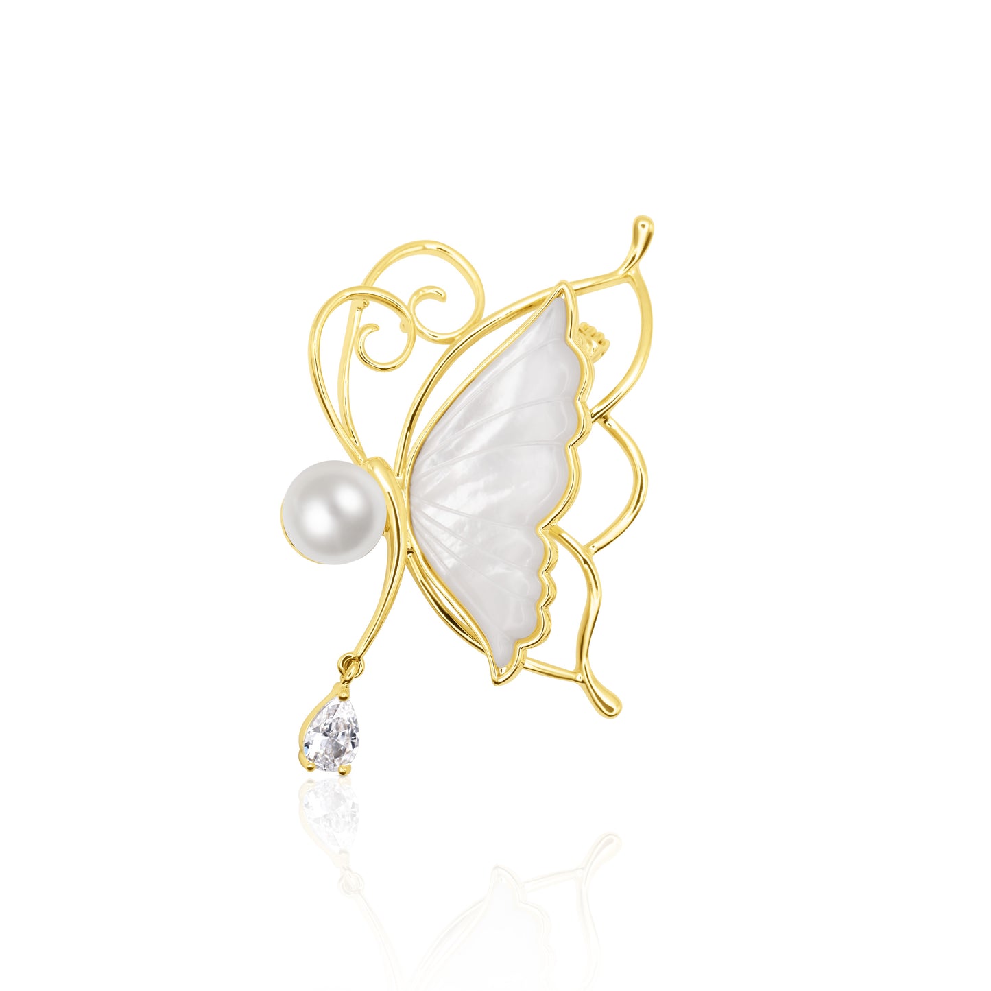 Whisperwing Butterfly Brooch featuring translucent white enamel wings framed in gold, a pearl body at the center, and a single teardrop crystal hanging delicately below. The piece rests on a white reflective background, highlighting its fairy-like elegance and subtle sparkle. A light and enchanting accessory perfect for weddings, spring events, or soft glam fashion.
