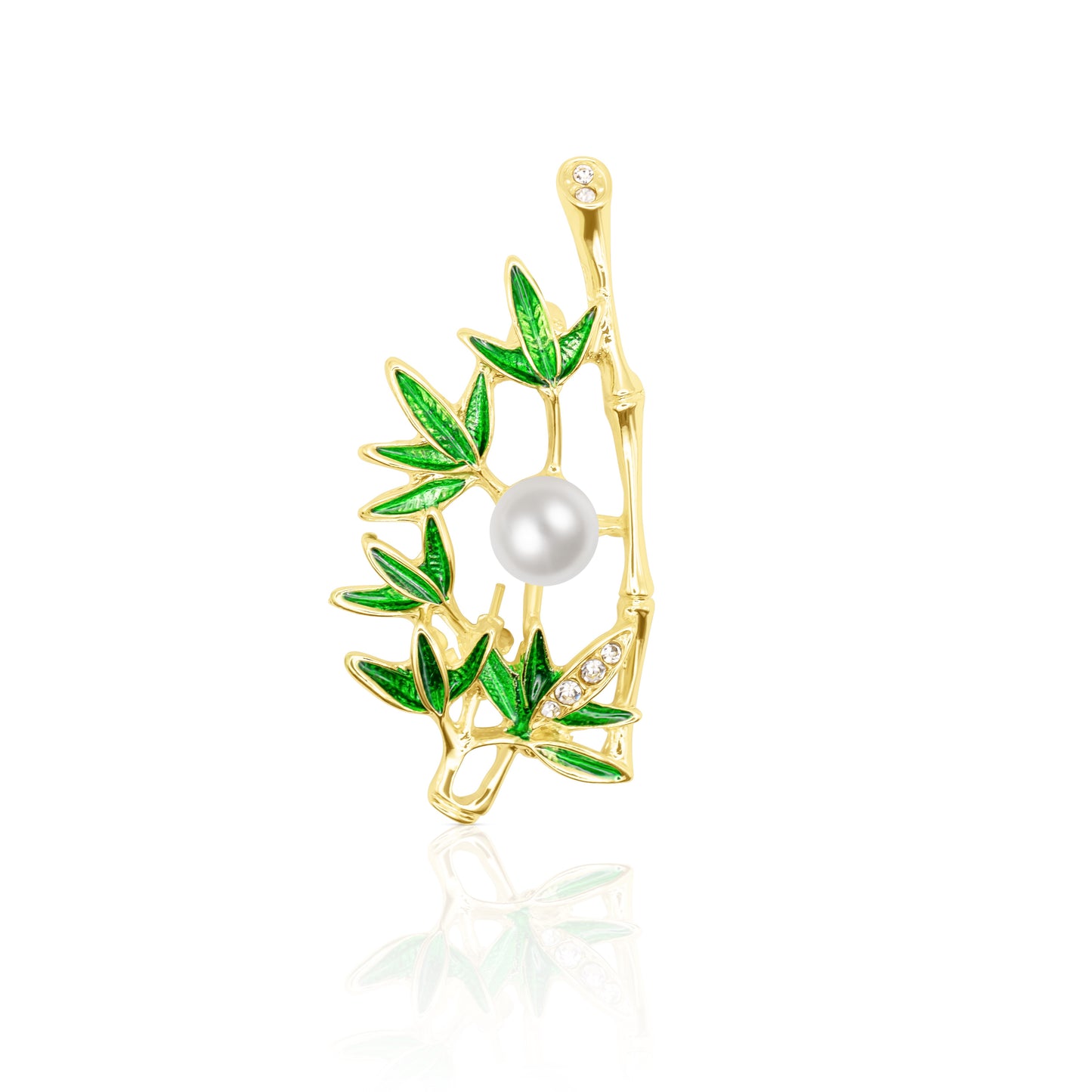 The Jade Whisper Brooch features a gold bamboo branch with lush green enamel leaves and a round pearl nestled at its center. Its vibrant foliage contrasts elegantly with the delicate white pearl. Photographed on a reflective white background, this nature-inspired pin radiates balance and vitality, making it an ideal piece for those drawn to earthy aesthetics and minimalist nature symbolism.