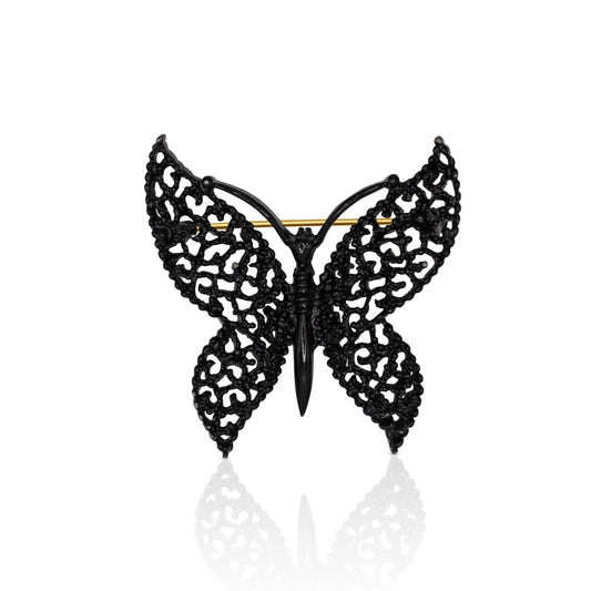 A striking black lace butterfly brooch crafted from matte black alloy, featuring intricate cut-out designs that evoke a delicate lace effect. The wings showcase a captivating texture, while the secure pin-back closure ensures easy attachment to clothing, bags, or scarves. Perfect for adding a touch of gothic allure to any outfit.