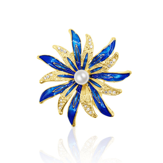 A stunning blue enamel flower brooch with sparkling crystal accents and a lustrous pearl centerpiece. The petal-like design radiates vibrant blue hues and intricate detailing, creating a captivating accessory perfect for adding a touch of elegance to any outfit. 