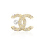 A glamorous gold-tone double C brooch encrusted with shimmering clear crystals, featuring a white faux pearl detail for added elegance. Stylish and iconic, this brooch is perfect for elevating both everyday and formal outfits with a luxurious flair.
