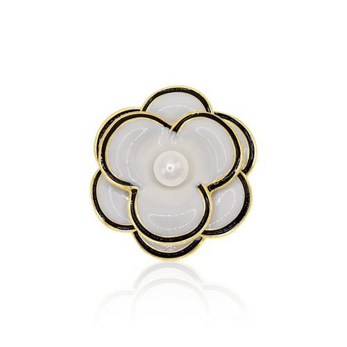 A chic black and white camellia flower brooch with a lustrous faux pearl center. The polished gold-tone base and secure pin closure make it an exquisite accessory for any vintage-inspired look.