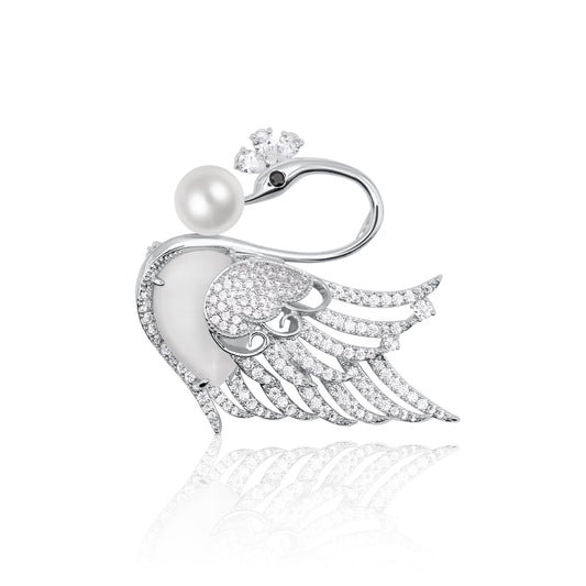 Silver-tone swan brooch adorned with sparkling crystals and a radiant pearl accent. A timeless and graceful accessory, perfect for adding a touch of sophistication to formal or casual wear.