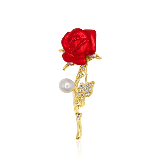 Enchanted Rose Brooch featuring a deep red enamel rose with sparkling crystal leaves and a pearl accent. An elegant statement piece perfect for romantic occasions.
