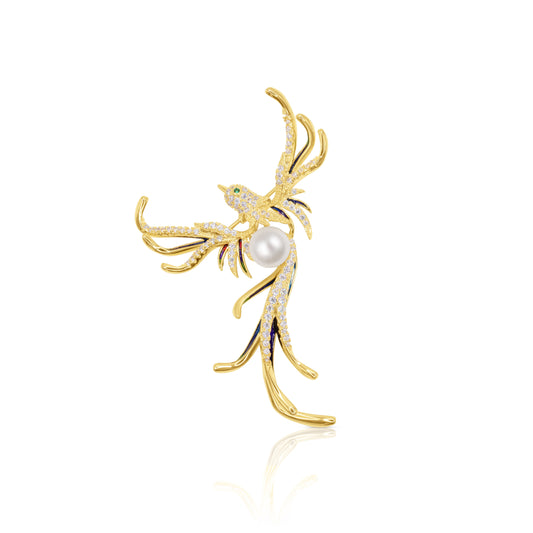 A striking gold-tone phoenix brooch adorned with sparkling crystals and a faux pearl accent. This intricately detailed accessory symbolizes rebirth and transformation, making it a stunning statement piece. Crafted with a secure pin backing, it offers a touch of timeless elegance to any outfit.