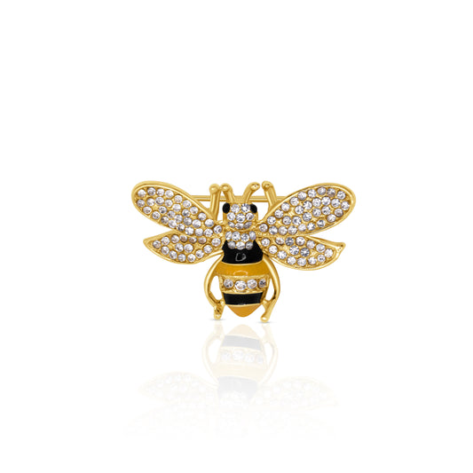A sparkling golden bee brooch adorned with clear crystals, set against a gold-tone base. The bee features delicate, intricately designed wings, encrusted with glistening stones, and a black enamel body with gold accents. This charming piece is perfect for adding a whimsical yet elegant touch to jackets, scarves, or bags.
