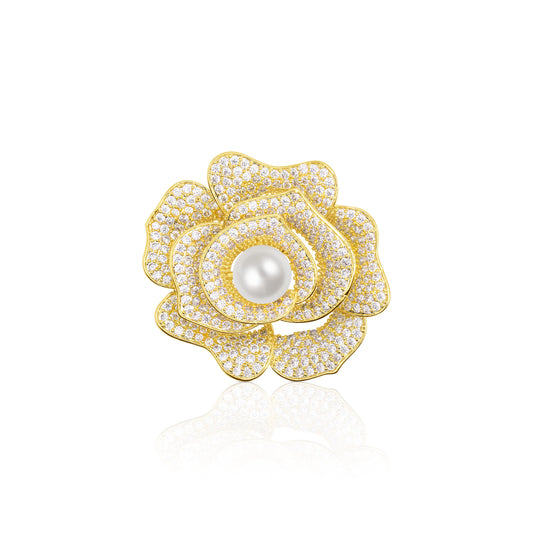 Alt Text (500 characters):
Close-up of the Golden Bloom Camellia Brooch, showcasing five layered, gold-edged petals studded with crystals and a round pearl at the heart. The brooch rests on a white reflective surface, amplifying its brilliance and symmetry. A radiant floral piece ideal for weddings, banquets, or adding a luxurious botanical element to coats and scarves.