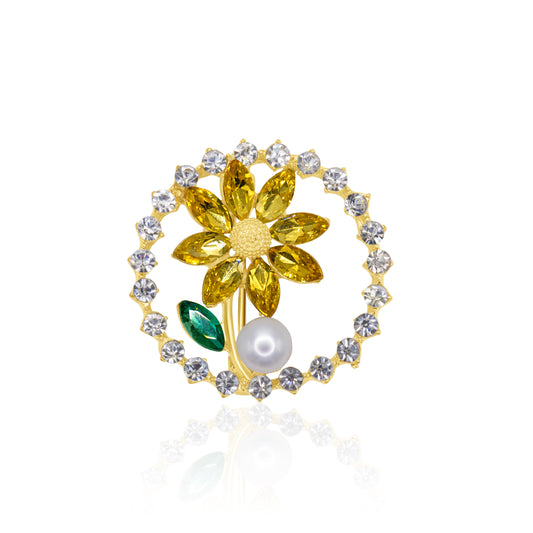 A golden sunflower-shaped brooch adorned with yellow crystals and a pearl accent, featuring a green crystal leaf, perfect for adding warmth to any attire.