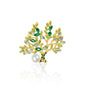 A striking gold-plated Tree of Life brooch adorned with vibrant green crystal leaves and a delicate faux pearl accent. This nature-inspired accessory features intricate branch detailing, symbolizing growth and renewal. The perfect addition to any outfit, this brooch combines timeless elegance with a touch of whimsy, making it a captivating statement piece for any occasion.