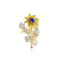 A sunflower-inspired brooch with a sapphire-blue crystal at the center, gold-tone detailing, and a pearl accent, perfect for brightening any look.